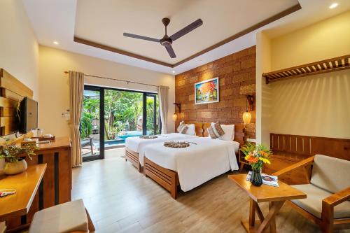 a bedroom with a bed and a living room at Olala An Bang Villa in An Bang