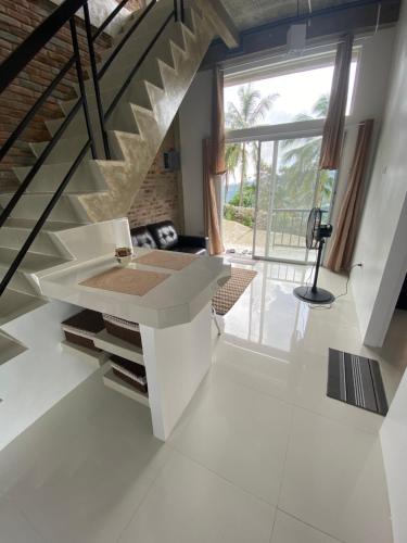 a living room with a staircase and a table at Casa De Pueblo Japanese Shrine Unit 2 in Valencia