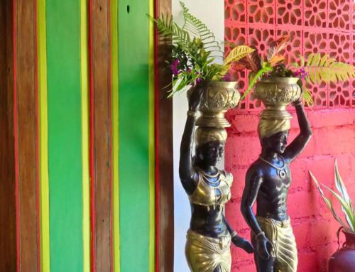 a statue of two girls holding a vase with flowers at Red Palms in Blahbatu