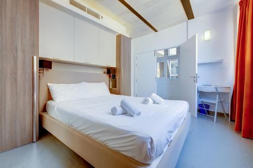 a bedroom with a bed with two towels on it at Luxurious 2BR Apartment in Valletta in Valletta