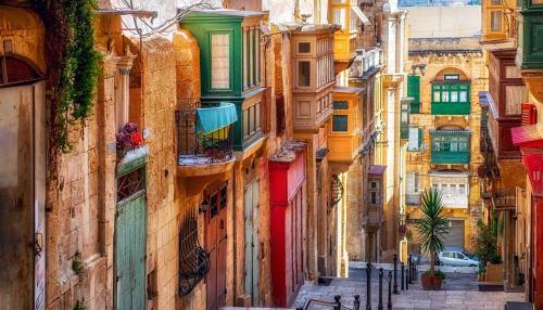 a view of an alley with colorful buildings at Luxurious 2BR Apartment in Valletta in Valletta