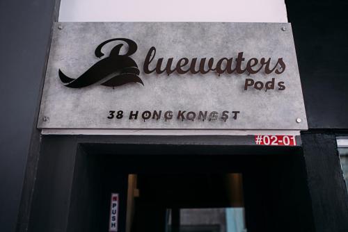 a sign on the front of asenalsenalpectspects at Bluewaters Pods 38 Hongkong St in Singapore