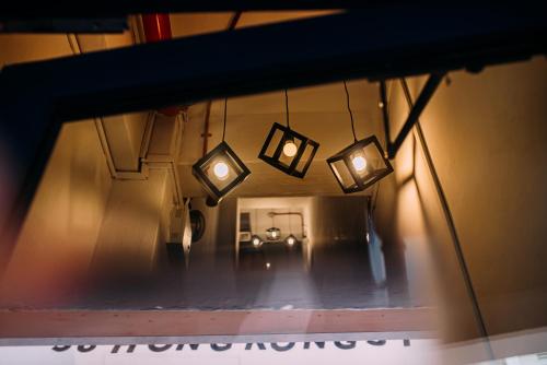 a mirror view of a hallway with lights at Bluewaters Pods 38 Hongkong St in Singapore