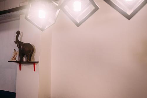 a room with white walls and a shelf with lights at Bluewaters Pods 38 Hongkong St in Singapore
