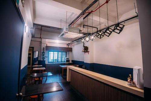 a view of a restaurant with tables and chairs at Bluewaters Pods 38 Hongkong St in Singapore