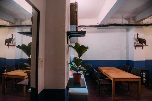 a room with two tables and chairs and a wall with blue at Bluewaters Pods 38 Hongkong St in Singapore