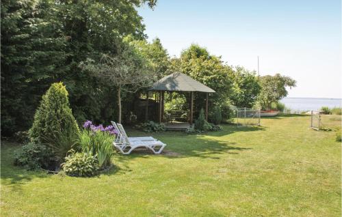 a gazebo with a white bench in a yard at 3 Bedroom Gorgeous Home In Nowe Warpno in Nowe Warpno