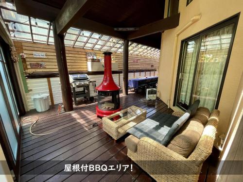 a living room with a fireplace on a deck at Roten Jacuzzi ・Morinoie in Metasequoia Namiki / Vacation STAY 3022 in Takashima