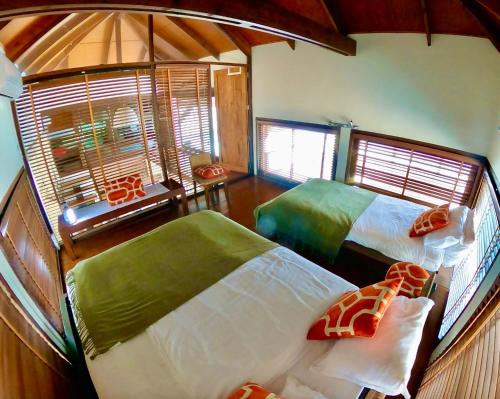 a bedroom with two beds and a window at Samet View Luxury Villa with Private Pool in Rayong