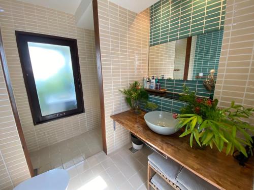 a bathroom with a sink and a mirror at Natural Villas -Samet View with Private Pool in Rayong
