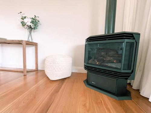 a television sitting in a living room with a fireplace at Seven Peaks Farm Stay in Beerwah