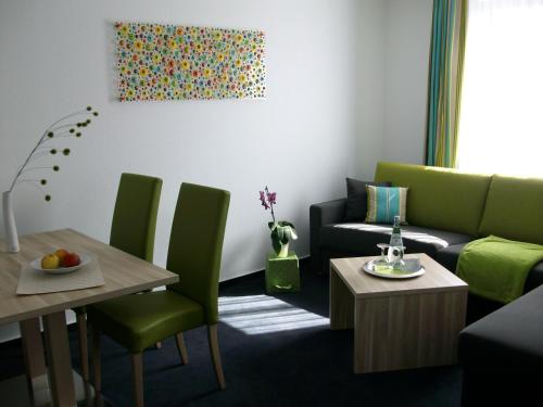 a living room with a couch and a table at Gästehaus Wilhelmshöhe in Butzbach