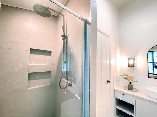 a bathroom with a shower with a glass door at Seven Peaks Farm Stay in Beerwah