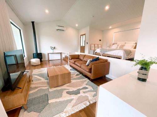 a living room with a couch and a bed at Seven Peaks Farm Stay in Beerwah