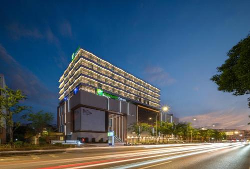 a building on the side of a street at night at Holiday Inn Express Shanghai Qingpu New City by IHG in Shanghai