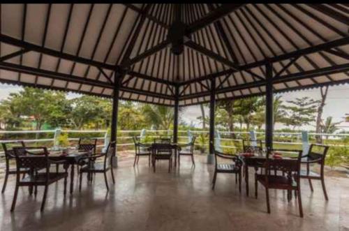 a group of tables and chairs in a pavilion at Lorin Beach Resort in Sijuk