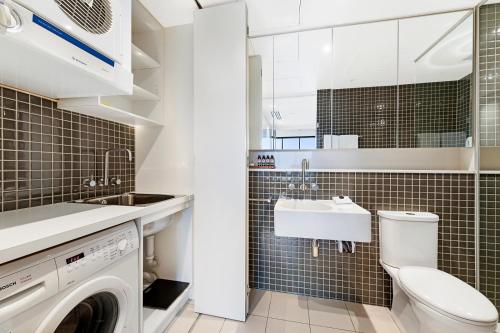 a small bathroom with a sink and a toilet at Luxury designer suite in most prestigious location in Melbourne in Melbourne