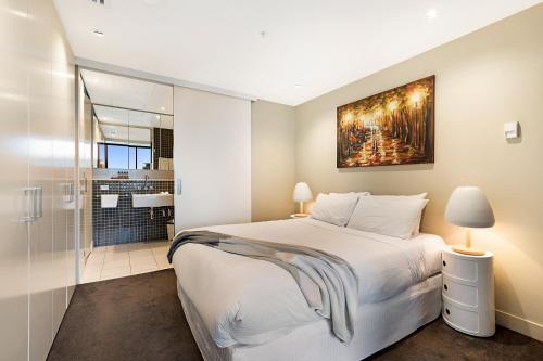 a bedroom with a king sized bed and a shower at Luxury designer suite in most prestigious location in Melbourne in Melbourne