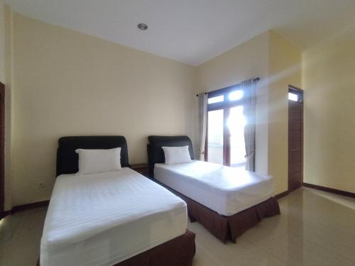 Katil atau katil-katil dalam bilik di Adi Pelita Sari Bali