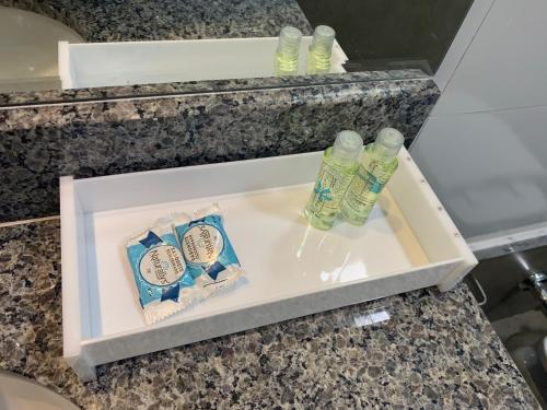 a drawer with two bottles ofodorizers on a counter at Éden Hotel in Rio Verde