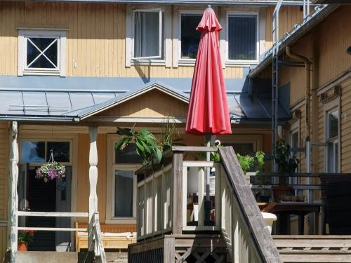 a red umbrella on top of a house at Simple private bedroom in a former Finnish School at the countryside in Hyrsylä