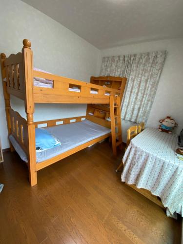 a bedroom with two bunk beds and a bed at 花沢民宿 in Odawara