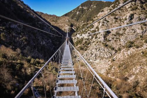 a suspension bridge over a canyon with a mountain at B&B A casa di Carla in Castelsaraceno