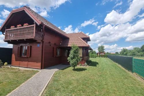a wooden house with a balcony on a yard at 54 Green Road Varaždin in Kućan Marof