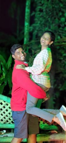 a man and a woman are holding a child at Casillda Munnar in Munnar