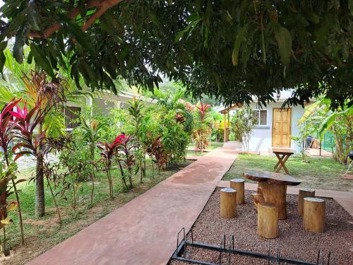 a park with a bench and a table and trees at La Belle Digue Don in La Digue