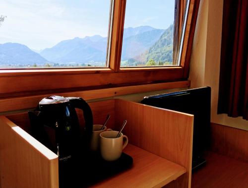 a kitchen counter with a coffee maker and a window at Sunrise Belvedere Pfronten in Pfronten