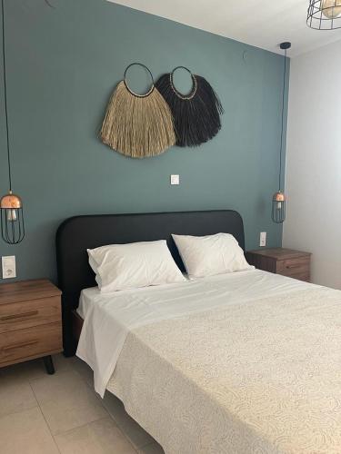 a bedroom with a bed with a blue wall at Kamino in Kalandra