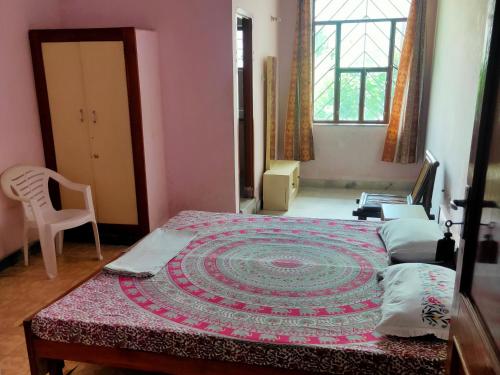 a bedroom with a bed with a rug on it at Jwala Niketan Guesthouse Private rooms in Jaipur
