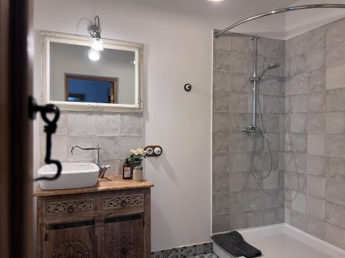 a bathroom with a sink and a shower at Apartamenti Kuldīgas Pilsdzirnavas in Kuldīga