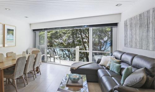 a living room with a couch and a table at Little Cove Court - Apt 10 in Noosa Heads