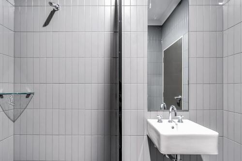 a bathroom with a sink and a shower at Illinois Hotel in Sydney