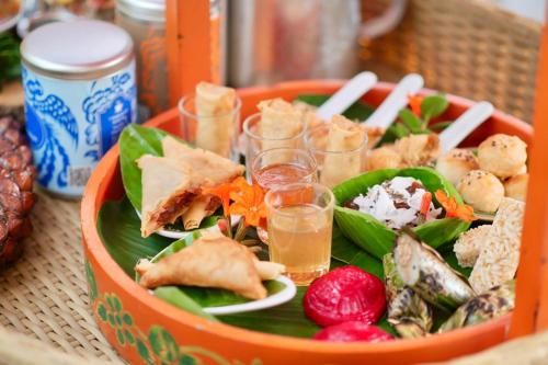 a bowl filled with food and drinks on a table at Proud Phuket, Naiyang Beach in Nai Yang Beach