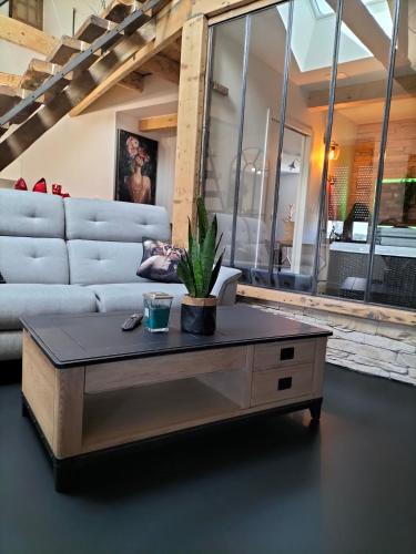 a living room with a couch and a coffee table at L'idyle loft érotique détente in Callac