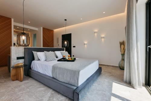 a bedroom with a large bed in a room at Milestones Naxos in Naxos Chora