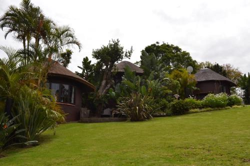 a house with a green lawn in front of it at Fish Eagle Manor in East London