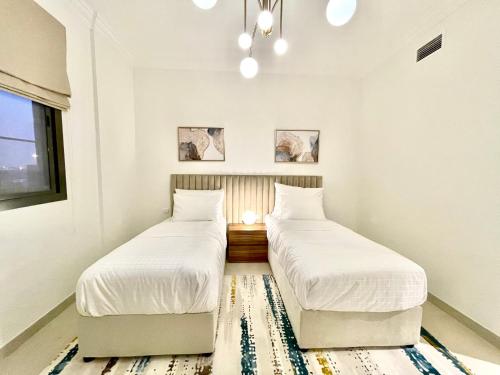 Кровать или кровати в номере GOODWOOD SUITES HOMES VACATION