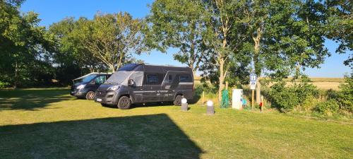 a camper van parked next to a fire hydrant at Wohnmobilstellplatz Nordseeliebe direkt am Deich - Dagebüll in Dagebüll