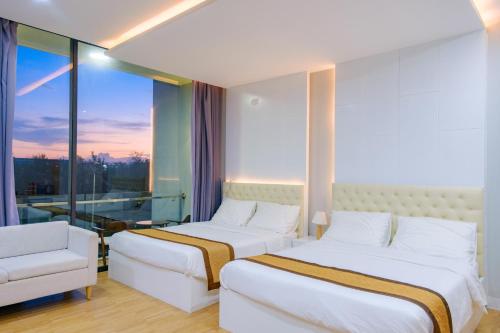 a hotel room with two beds and a window at Khách sạn Minh Long in Tuy Hoa
