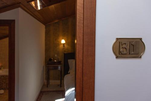 a room with a number on the wall and a bed at Hagiati Anastasiou Hotel & Spa in Naousa Imathias