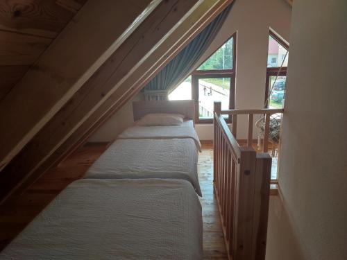 a row of beds in a room with a window at Monte Pino Lux Apartments in Žabljak