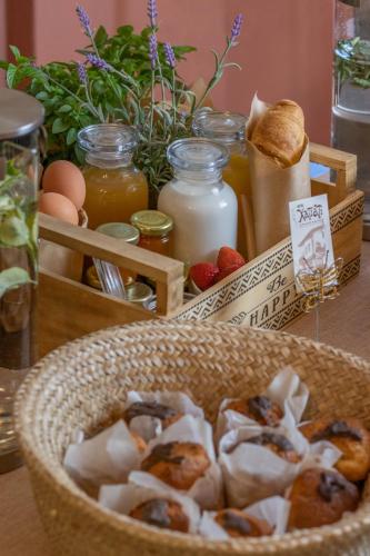 a basket of food on a table with eggs and bread at Hagiati Anastasiou Hotel & Spa in Naousa Imathias