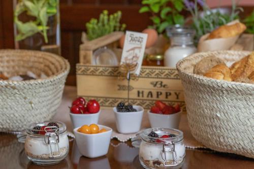 a table with bread and eggs and baskets of food at Hagiati Anastasiou Hotel & Spa in Naousa Imathias