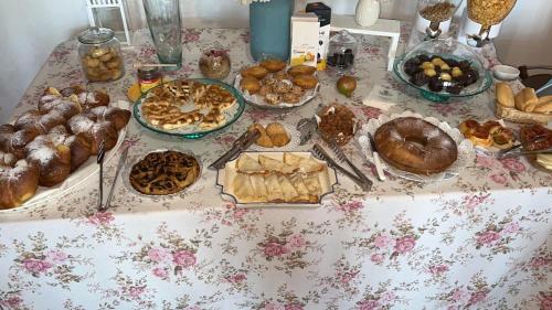 a table topped with lots of different types of pastries at B&B Antico Casale in Fuscaldo