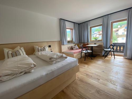 a bedroom with a bed and a table and chairs at Waldruh in Wiesing