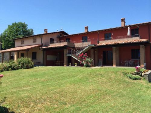 a large house with a yard in front of it at Agriturismo Polla in Camporgiano